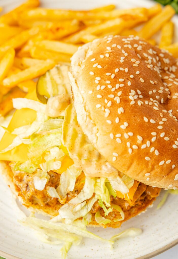 A sloppy Joe with a Big Mac ground beef mixture between two sesame seed buns.