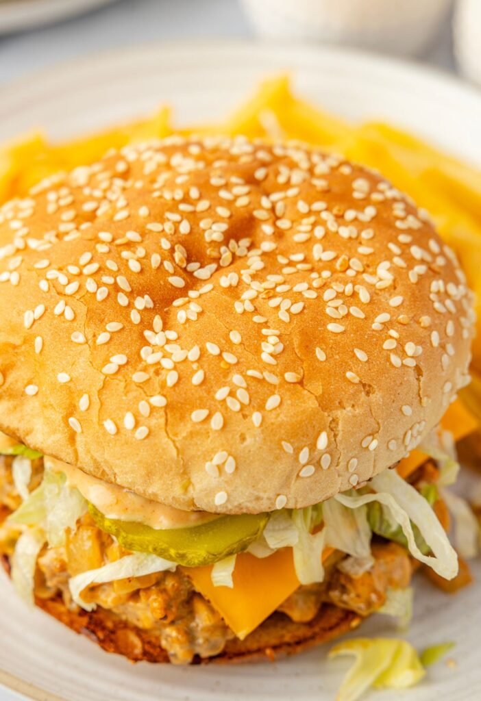 Top of a sloppy joe showing the sesame seed bun.