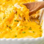 Side of white casserole dish with the casserole inside of it