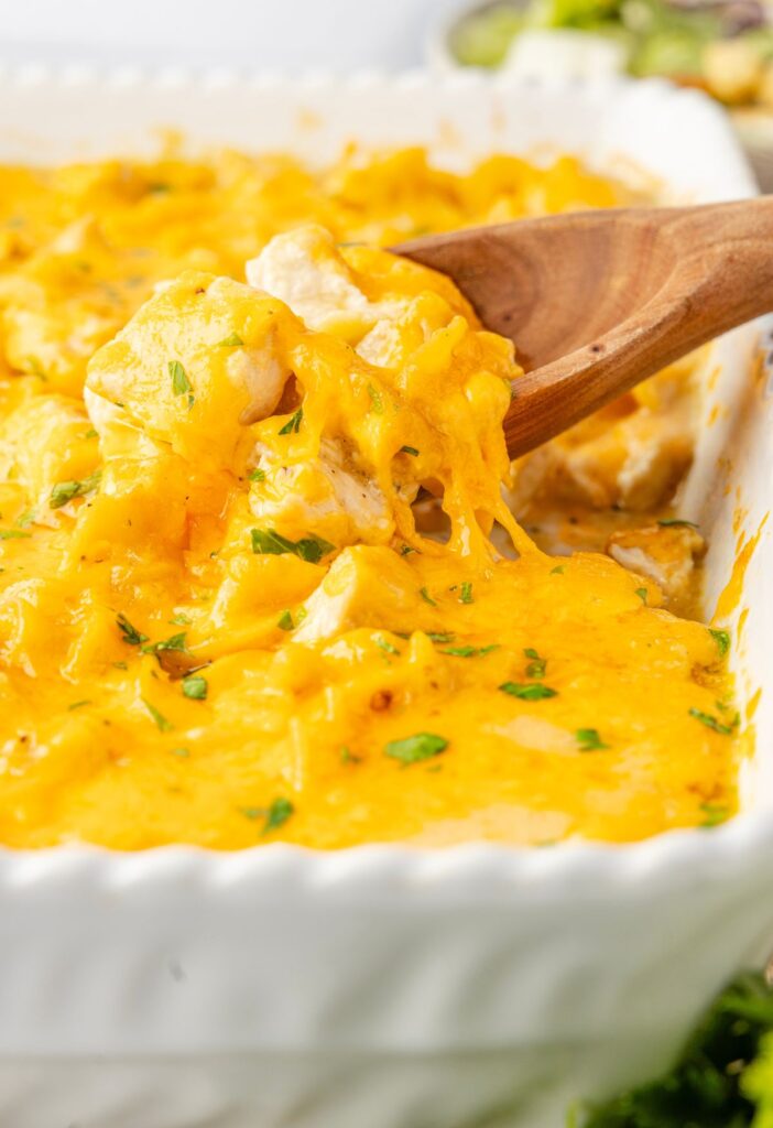 Side of white casserole dish with the casserole inside of it