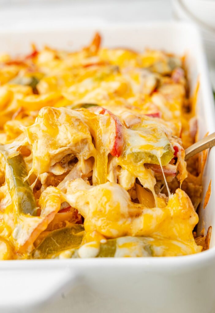 Side view of the pan with a spoon scooping some of the casserole out.