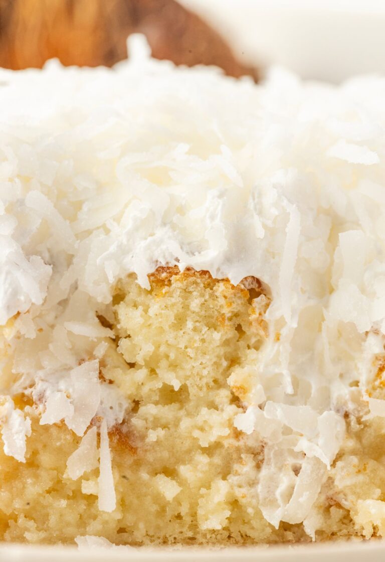 A slice of the poke cake so you can see the coconut cream poke filling.