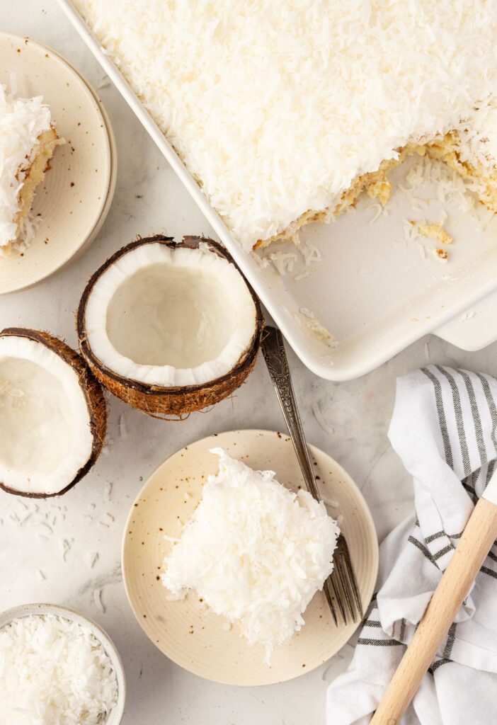 A slice of cake on a plate and the cake pan of the cake next to it.