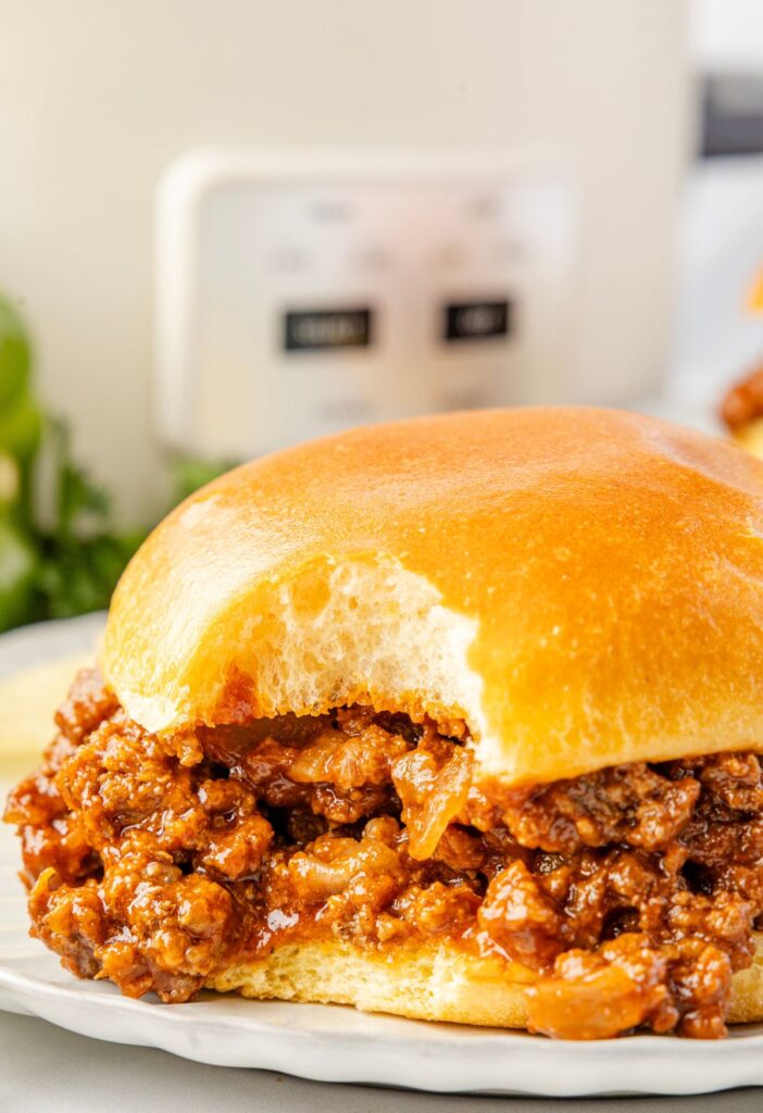 A sloppy Joe with a bite taken out of it.