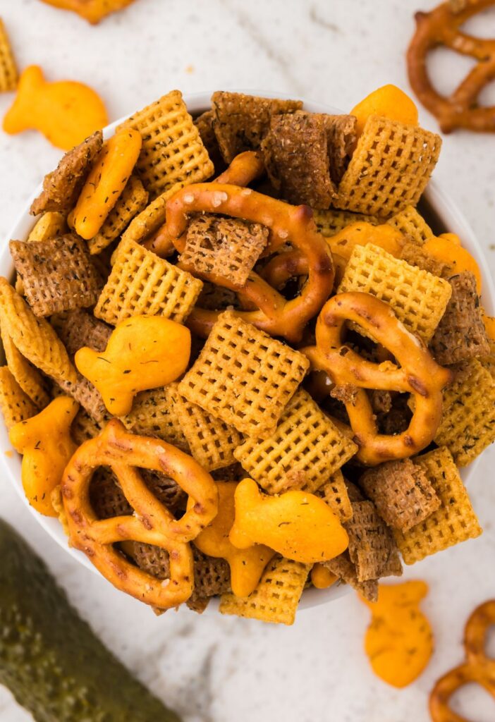 A bowl of savory snack with dill pickle seasoning and melted butter.