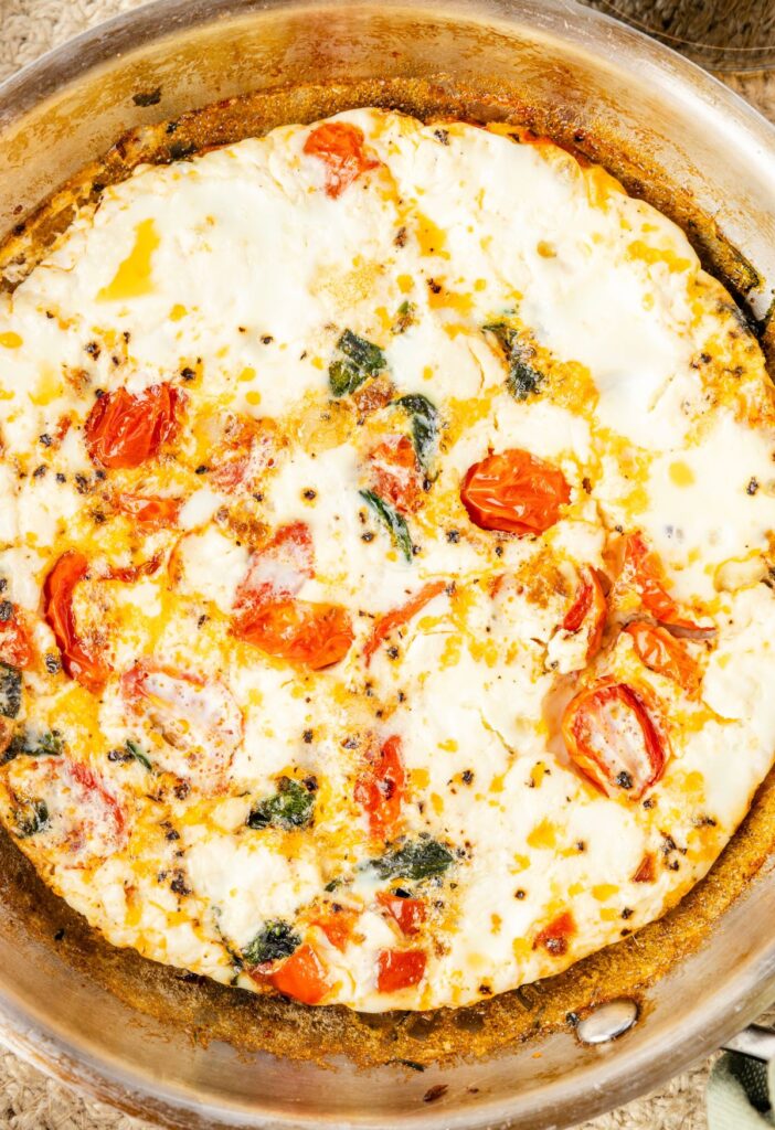 Skillet pan with the egg white frittata inside of it, cooked and ready to serve.