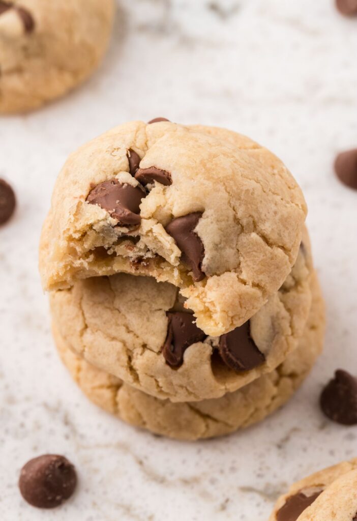 Stack of cookies with the top cookie having a bite taken out of it.