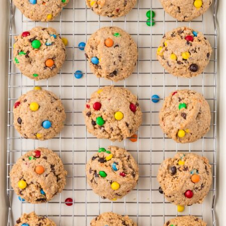Cooling rack of baked monster cookies with no flour in them.