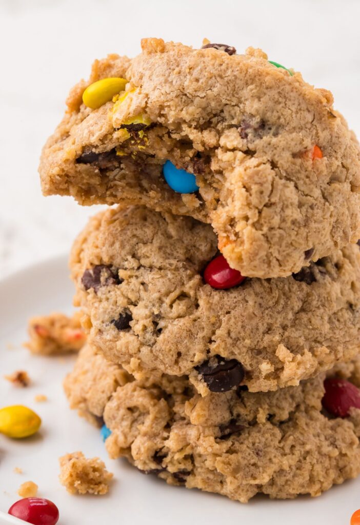 A bite taken out of the top cookie on the stack of them. 