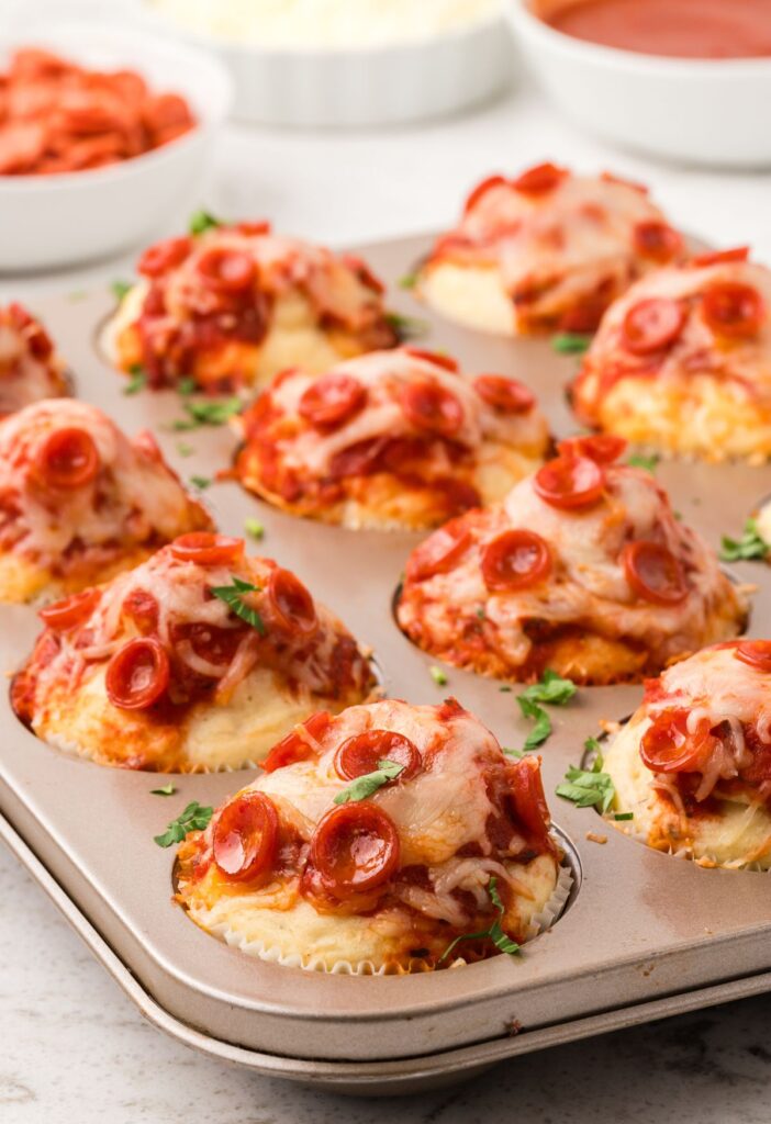 muffin pan with pizza muffins inside of it