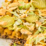 Side pic of the tater tot casserole with a piece taken out of it to show the middle.