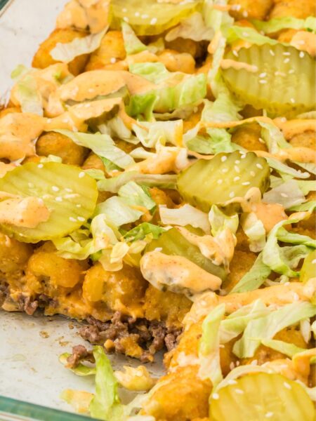 Side pic of the tater tot casserole with a piece taken out of it to show the middle.