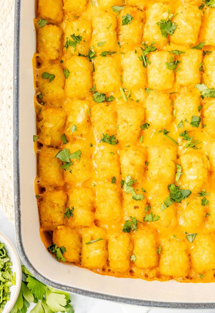 Top of the casserole dish with crispy cheesy tater tots.