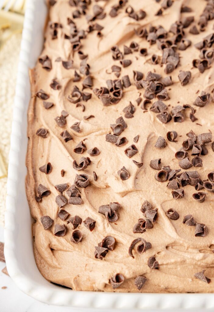 Poke cake inside a white cake pan