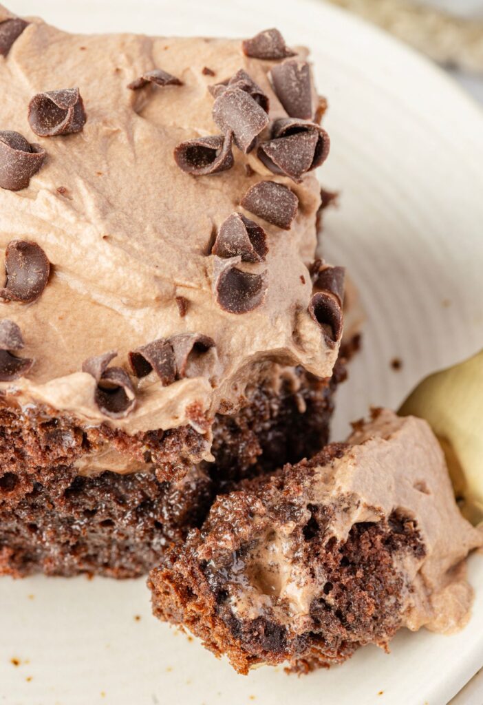 A slice of poke cake with a fork