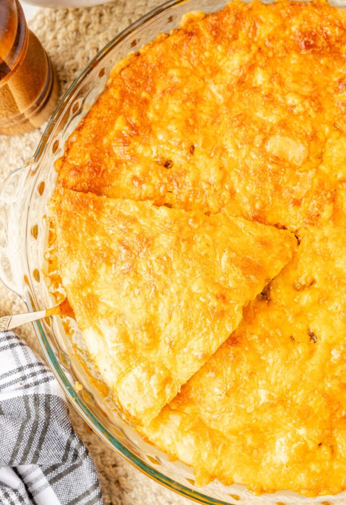 Hamburger pie baked in a pie plate with serving spatula.