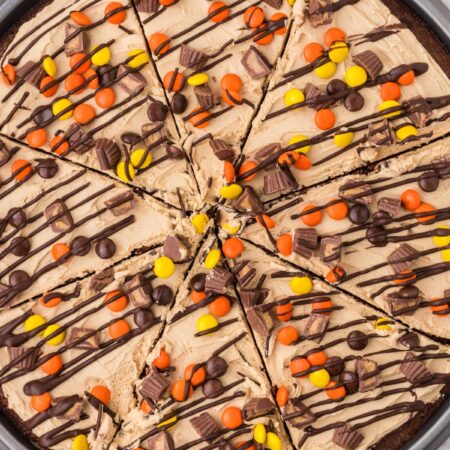 The baked and frosted brownie pizza inside the pizza pan.