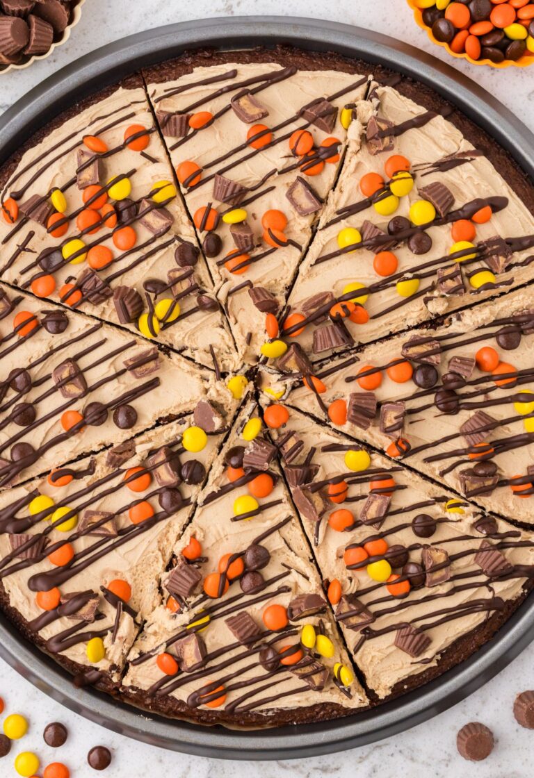 The baked and frosted brownie pizza inside the pizza pan.