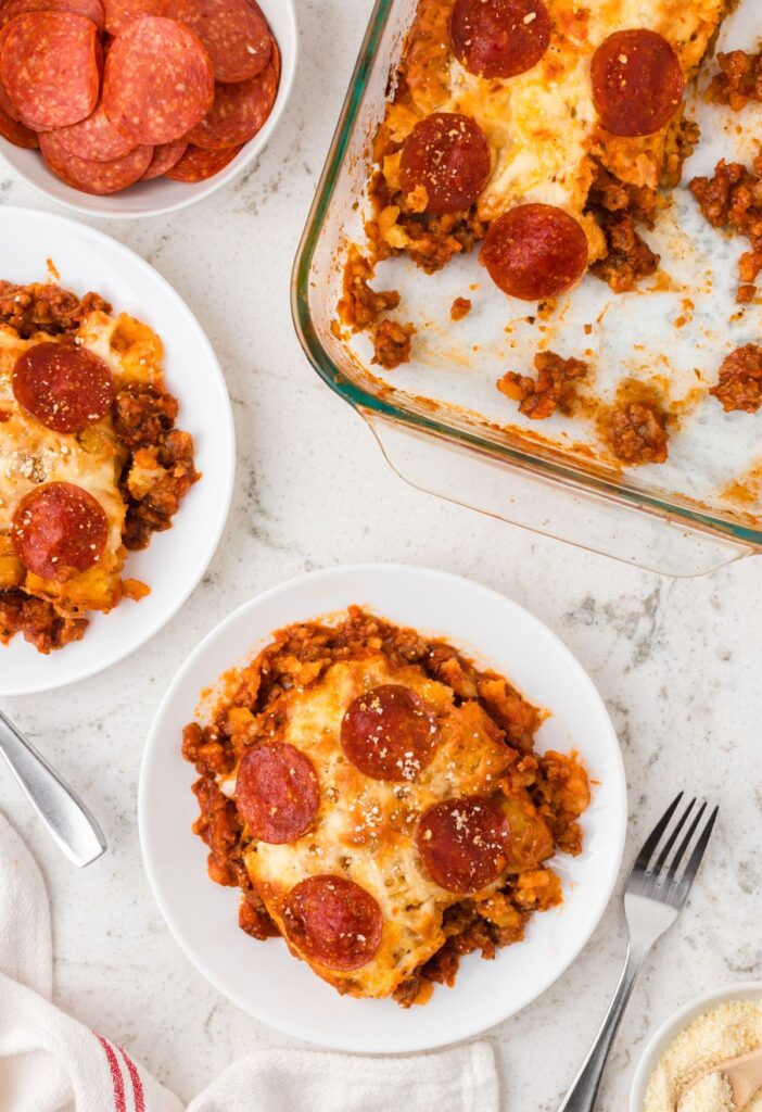 Serving plate of the tater tot casserole and the casserole dish next to it.