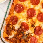 Top view of the tater tot casserole with a portion take out of the casserole dish.