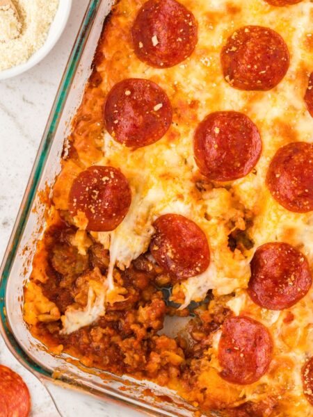 Top view of the tater tot casserole with a portion take out of the casserole dish.