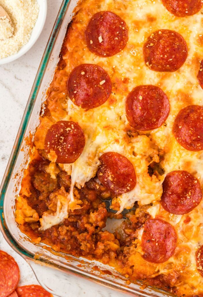Top view of the tater tot casserole with a portion take out of the casserole dish.