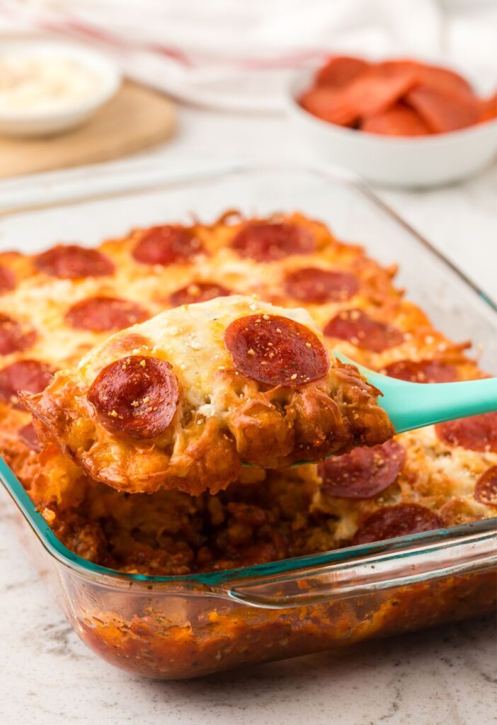 Side view of a serving spatula with a piece of the casserole on it.