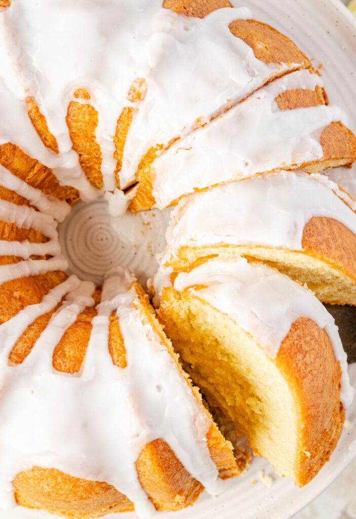 The top of the glazed bundt cake cut into slices for serving.