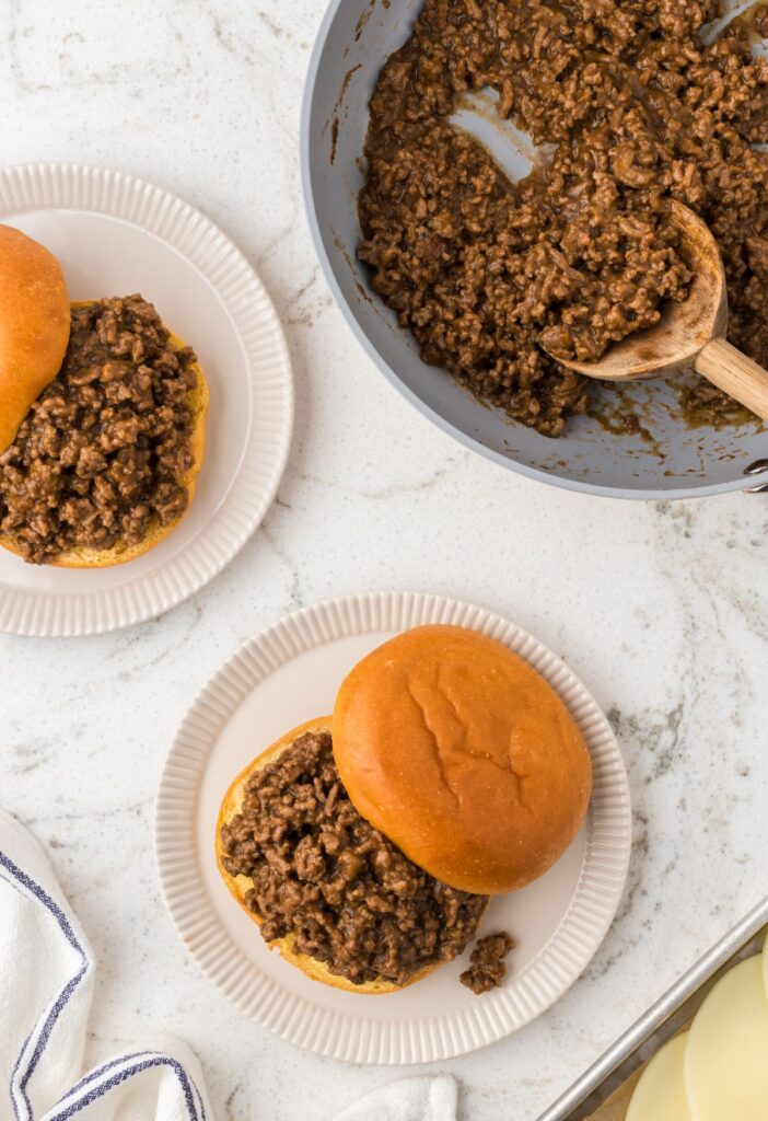 Top view of the sloppy Joe filling inside a skillet pan with a serving spoon.