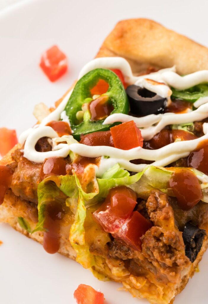 One slice of the taco pizza with toppings