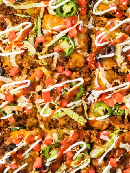 Top view up close of the baked taco pizza with taco toppings.