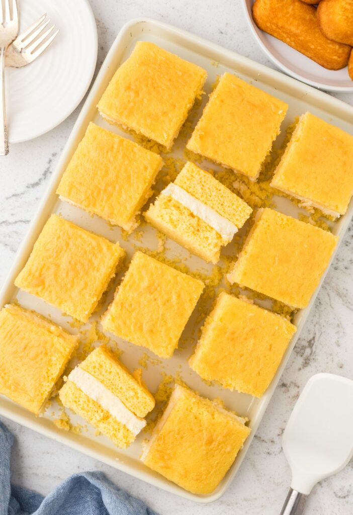Tray of the Twinkie Cake with Twinkies in the background.