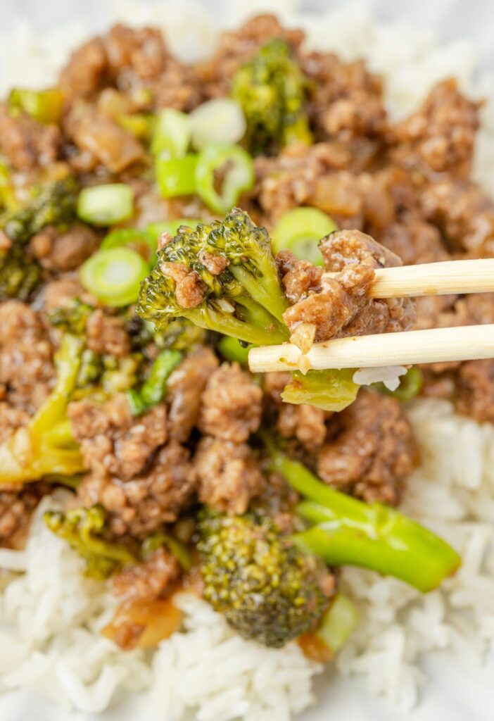 Beef and broccoli with chopsticks on a serving plate