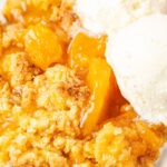 serving of the cake batter peach cobbler with ice cream on it
