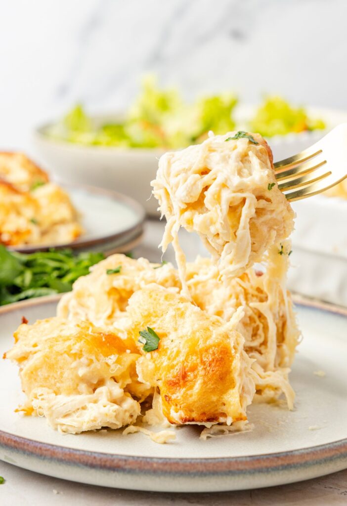 A fork picking up a bite of the biscuit casserole