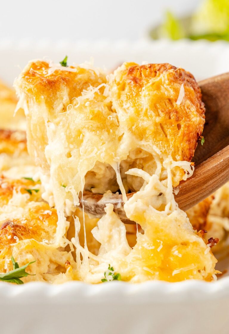 Close up of a scoop scooping up some of the biscuit casserole with cheese