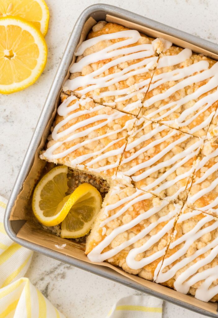 Coffee cake with fresh lemon and lemon zest inside the baking pan.