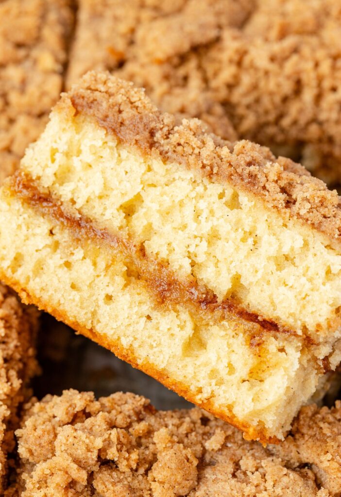 A slice of coffee cake with the cinnamon sugar center showing.