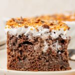 Slice of the butterfinger cake on a white plate.
