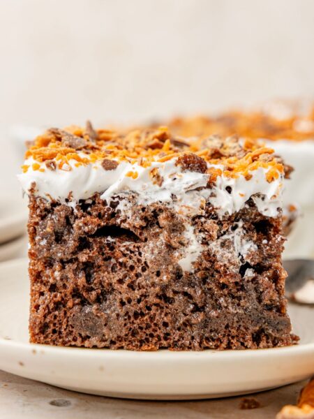 Slice of the butterfinger cake on a white plate.