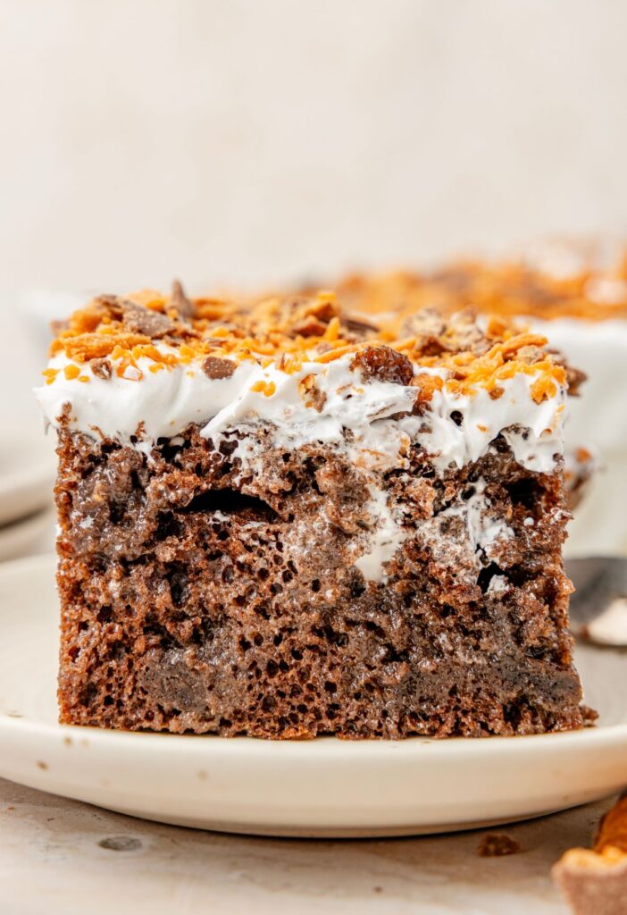 Slice of the butterfinger cake on a white plate.