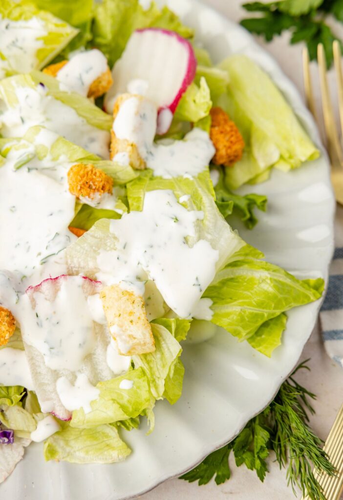 A salad with ranch over it