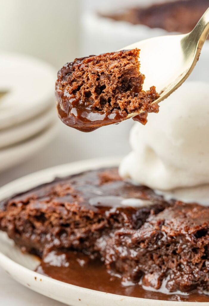 A spoon with some of the chocolate cobbler on it