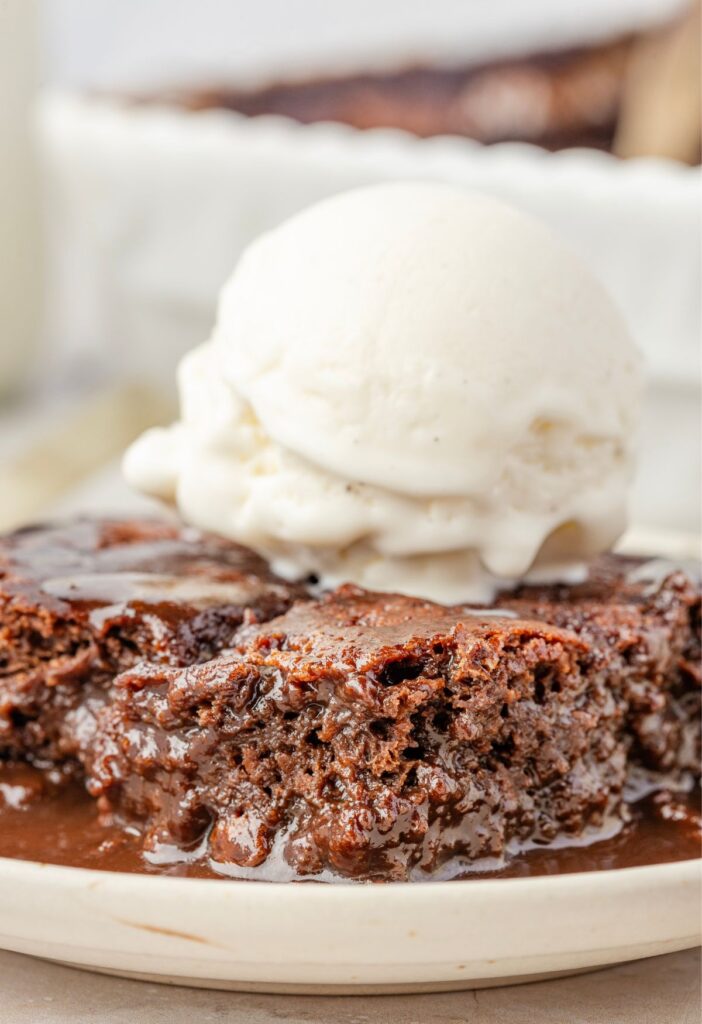 A side view of the cobbler on a plate topped with ice cream