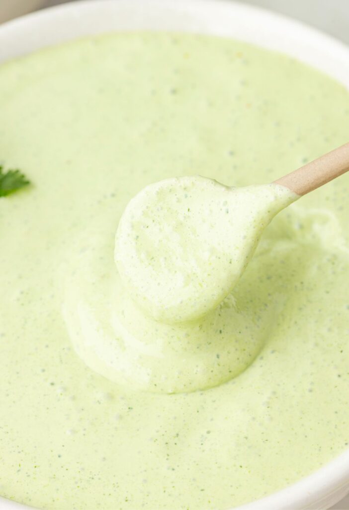A white bowl of cilantro lime sauce