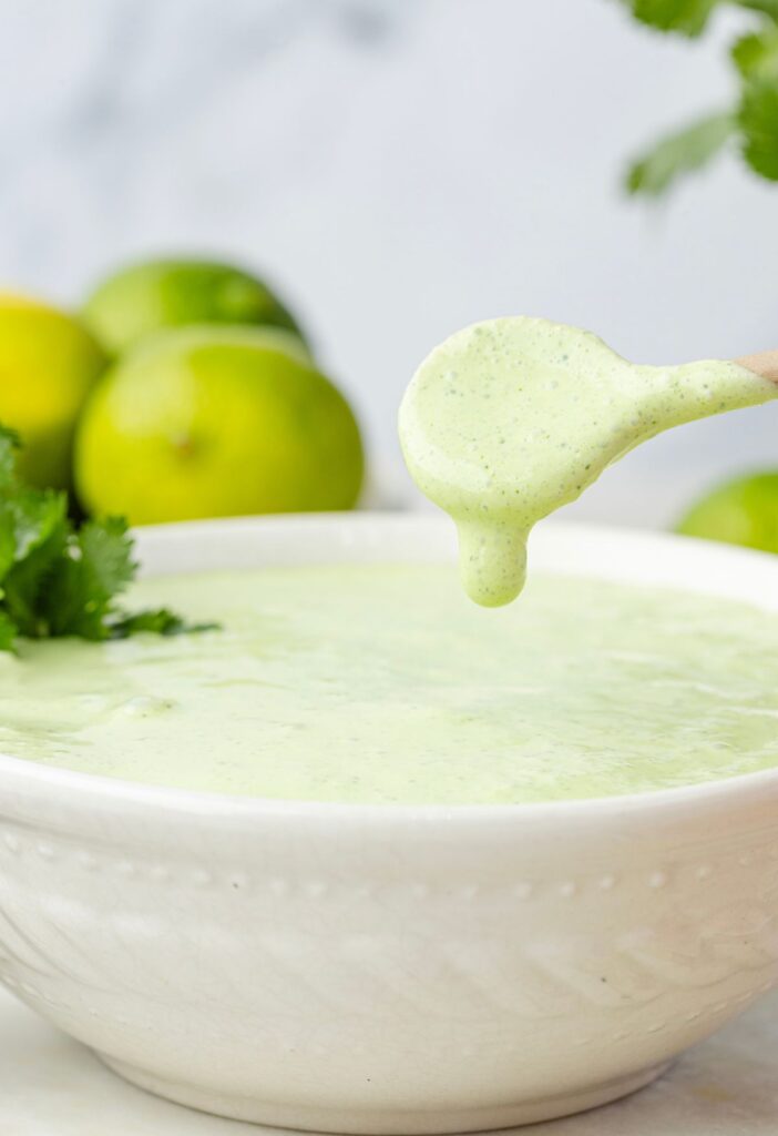 A bowl of lime sauce with a spoon scooping some out