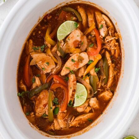 Inside of the slow cooker with the chicken fajita filling cooked and ready to serve.