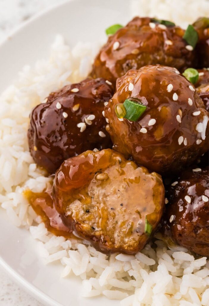 A serving of meatballs on top of white rice