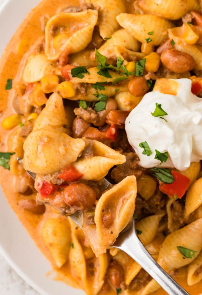 A plate of the cheesy taco pasta with a fork