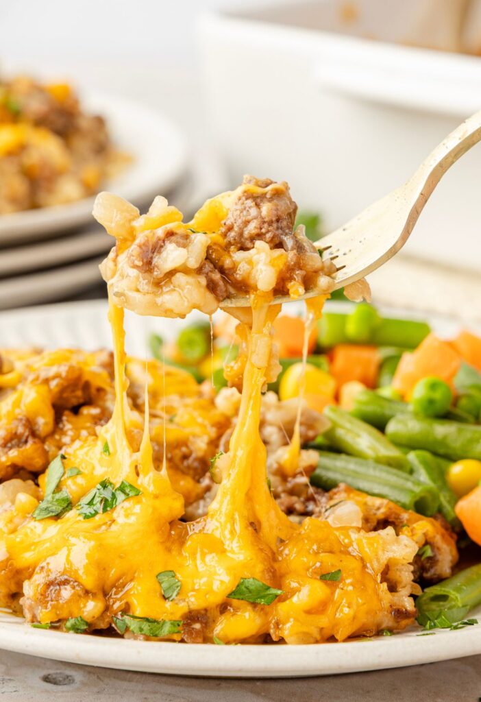 A fork with a bite of the casserole on it